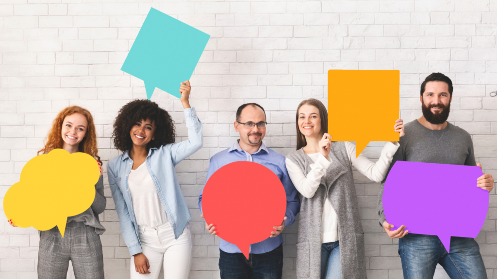 Diverse individuals holding speech bubbles, representing communication and the exchange of ideas.